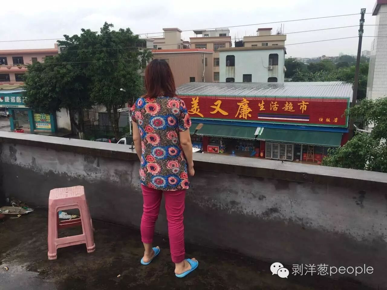 郑琳望着街对面的超市陷入沉思。开个小超市，是她一直的梦想。　新京报记者王佳慧 摄