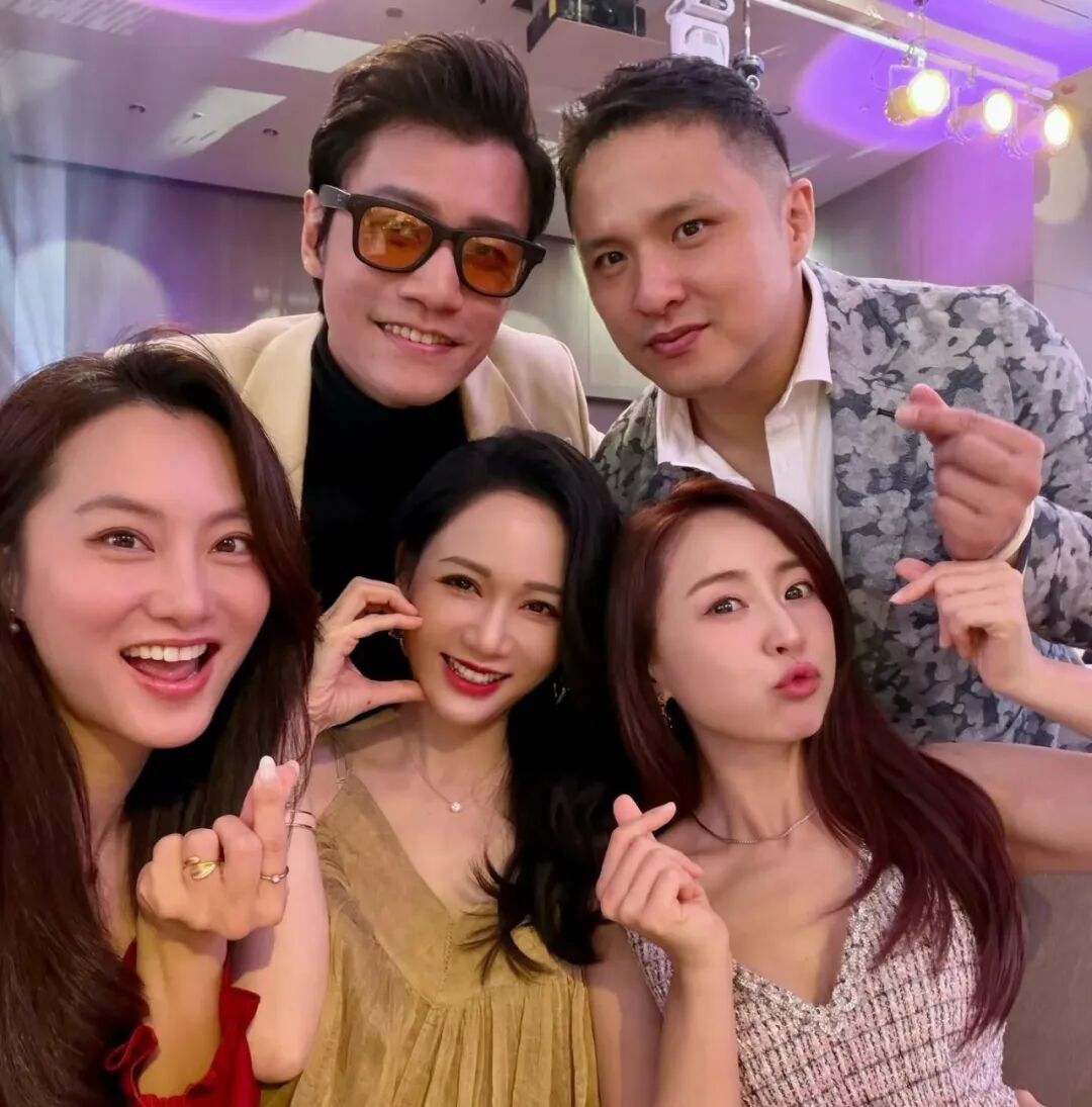 Group of five friends in formal wear take a selfie at an event