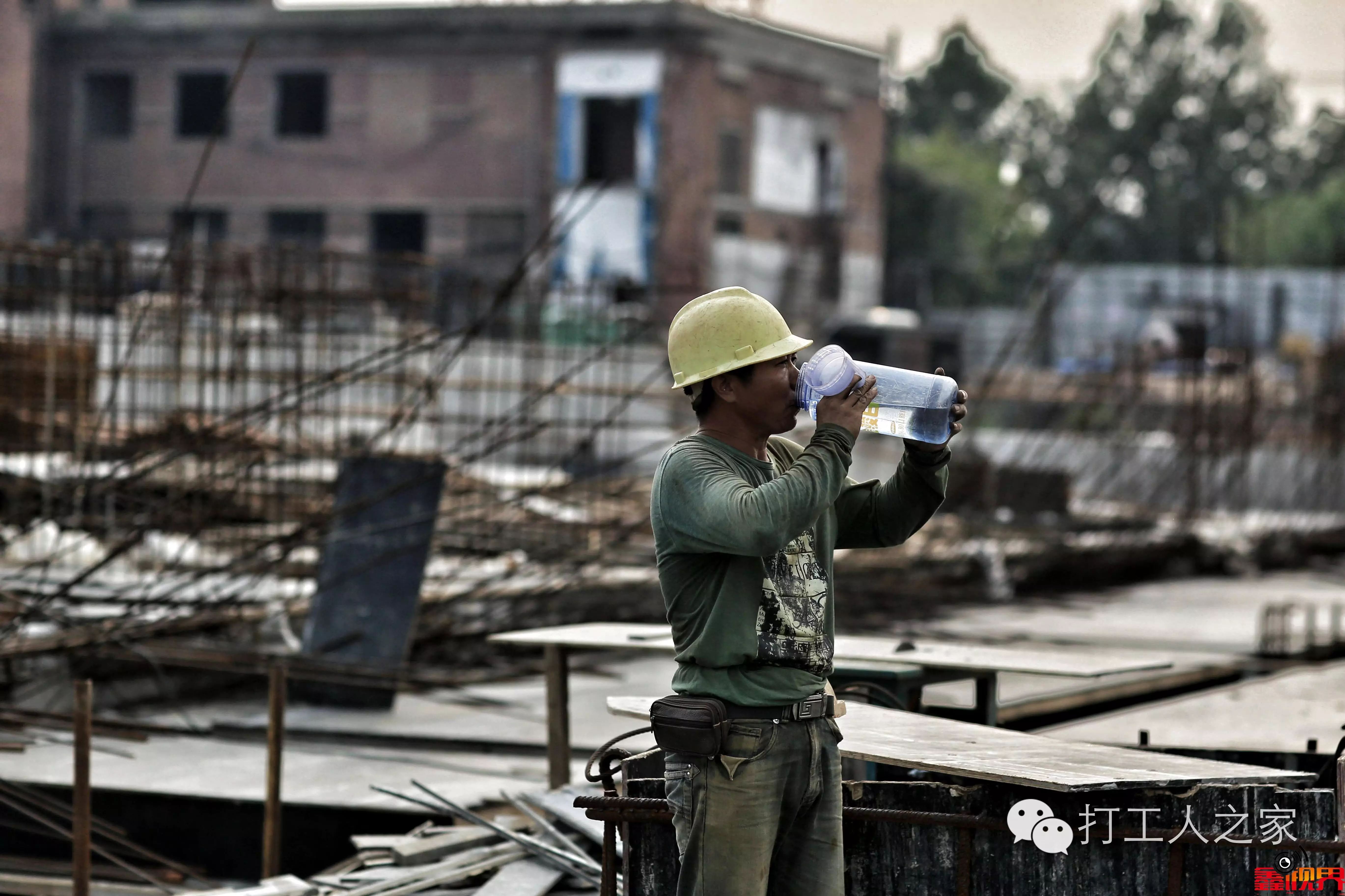 胡笑生在建筑工地施工,汗水湿透了衣背.