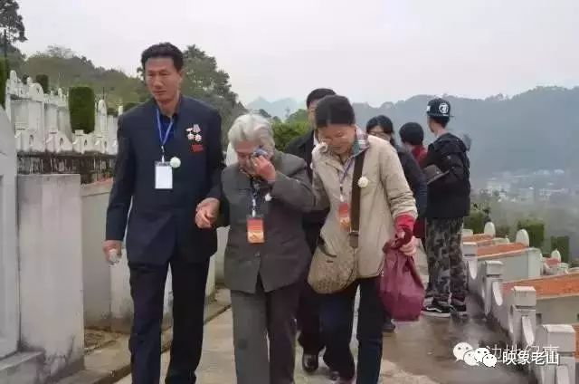 王昌群老人和女儿刘丰来到刘明烈士在麻栗坡陵园的墓前