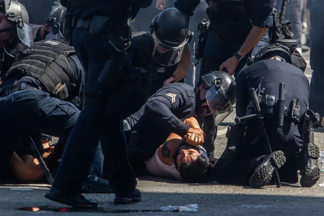 Los Angeles Police Department officers arrest a protester in front of the LA Federal Building on Sunday.