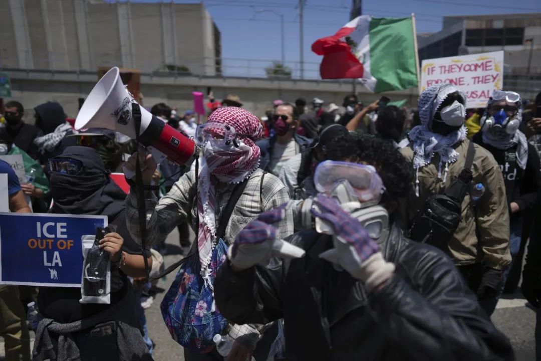 Protesters confront a line of National Guard troops.