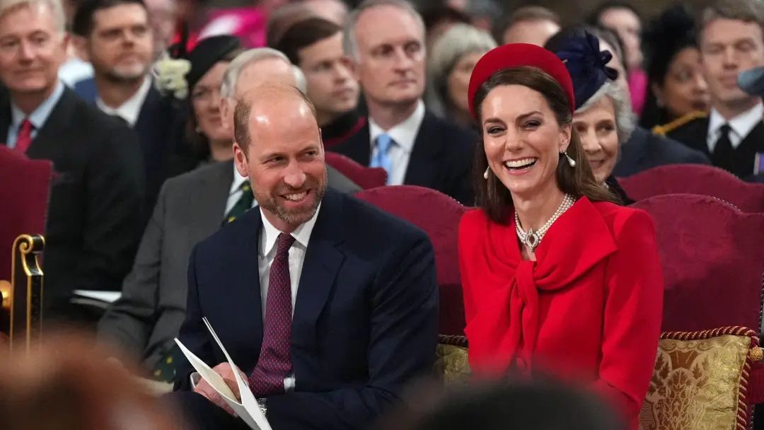 William and Catherine smile as they sit in the church.