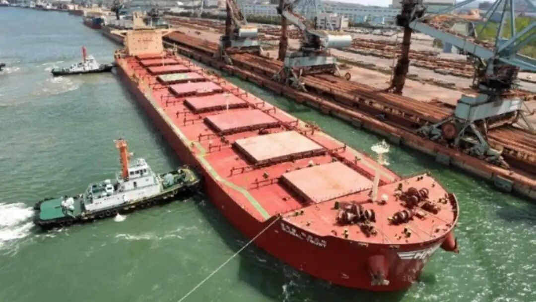 red dry bulk ship in port