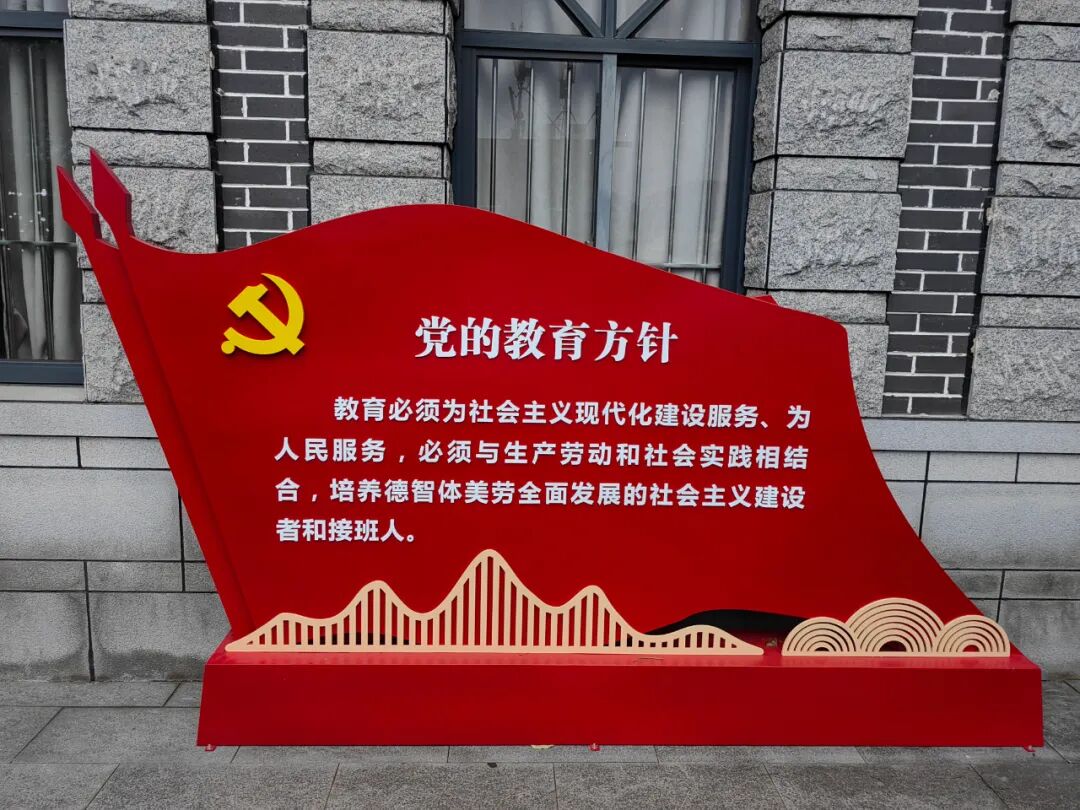 而今树立在广益中学大门外的党的教育方针标语牌鲜艳夺目(摄于