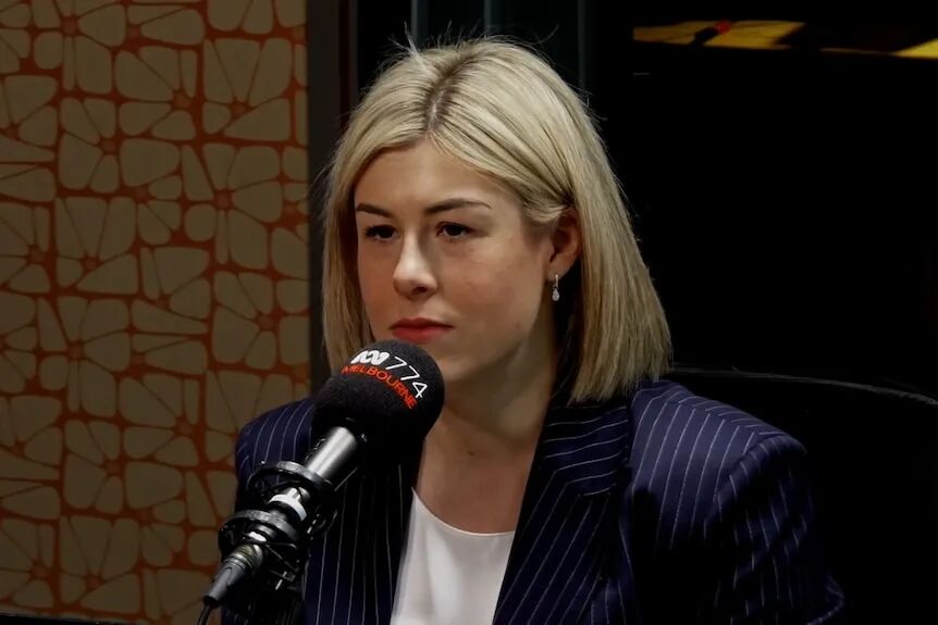 Opposition Leader Jess Wilson speaking into a microphone.