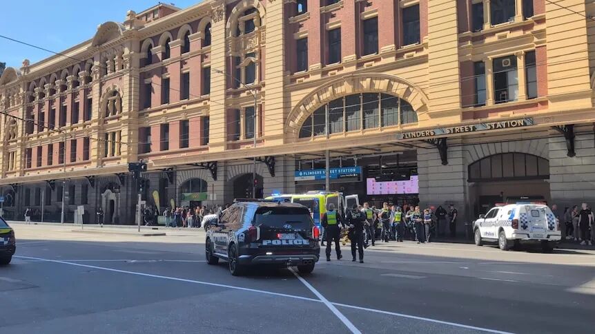 Multiple police cars and an ambulance visible at the Elizabeth street end of Flinders st station