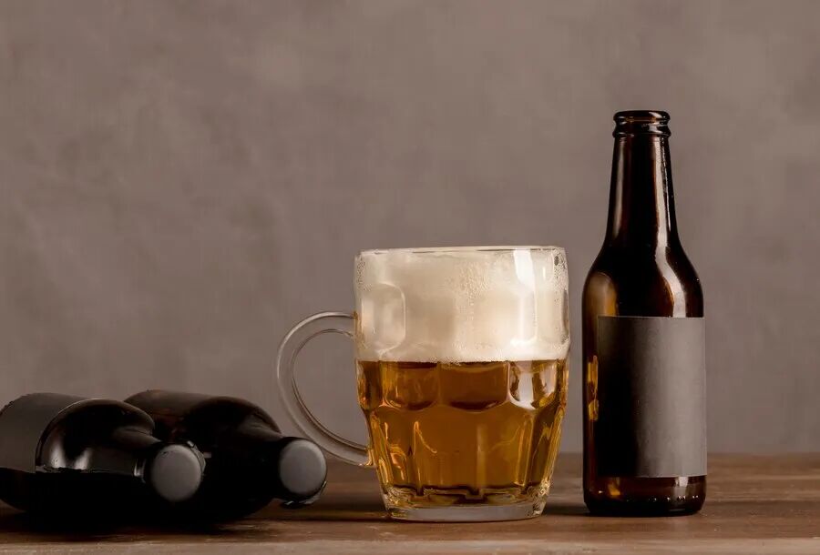 cda67df0f591c487a38a8f89639d8d90_glass-beer-with-foam-brown-bottles-beer-wooden-table_23-2148215830.jpg