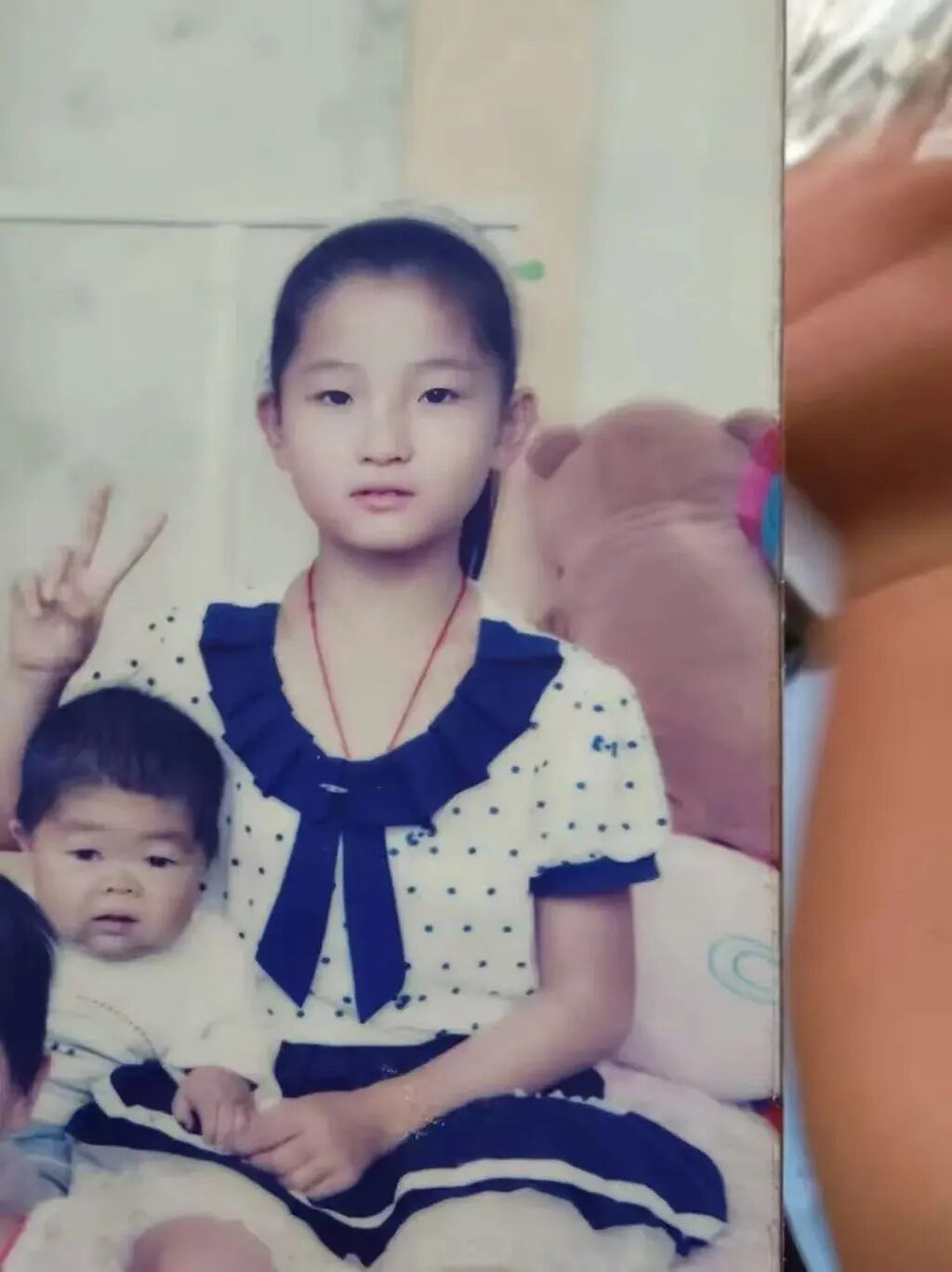 Wang Junming sits beside his younger sister, Xiaoling, when she was a child. Photo: Handout