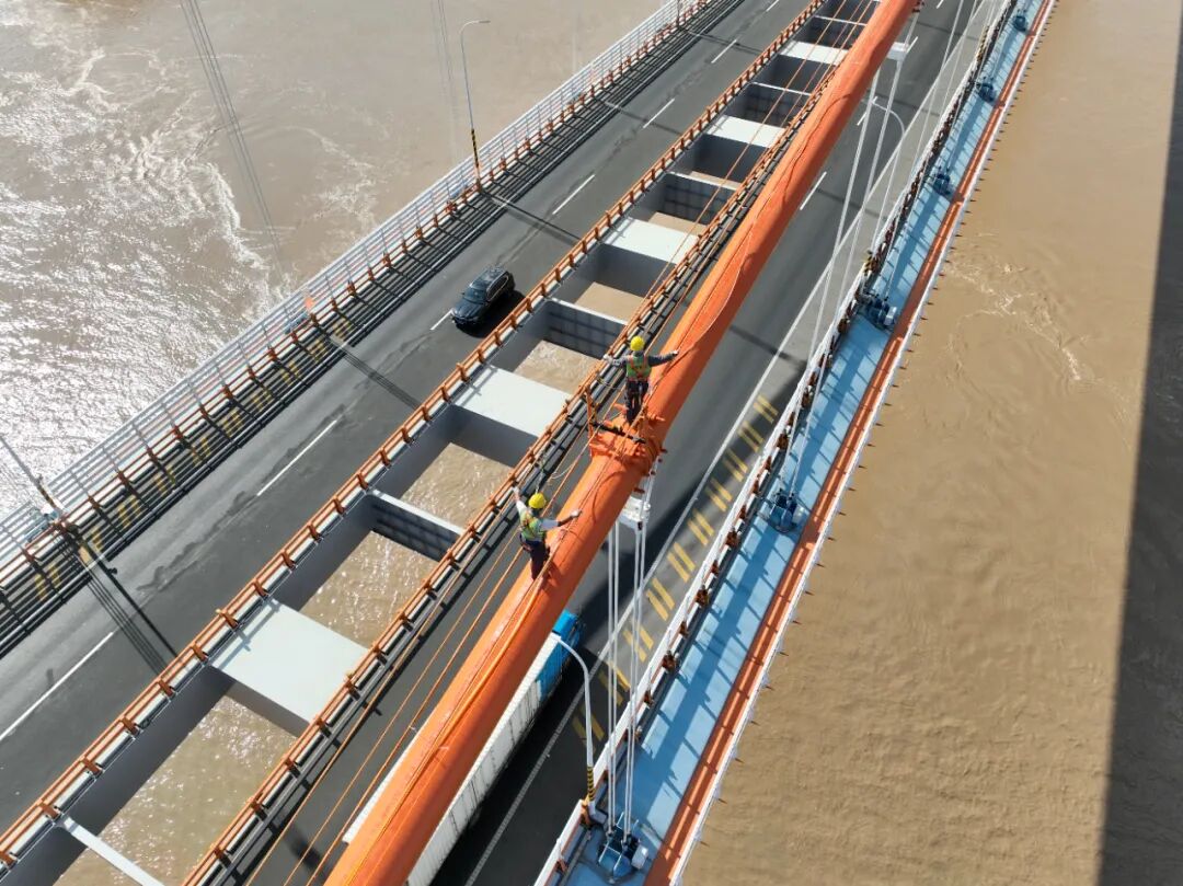 工作人员在主缆上安装送气管道。周炳宇&nbsp; 摄