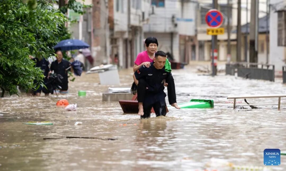 A rescuer helps evacuate a senior resident from a flood-affected area in Congjiang County, southwest China's Guizhou Province, June 24, 2025. (Photo by Wu Xingke/Xinhua)