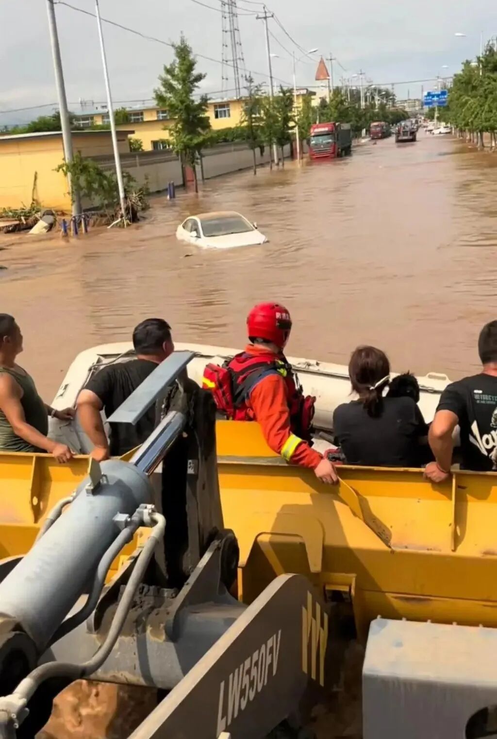 Wang used the mechanical bucket of his bulldozer to carry flood victims to safety. Photo: handout