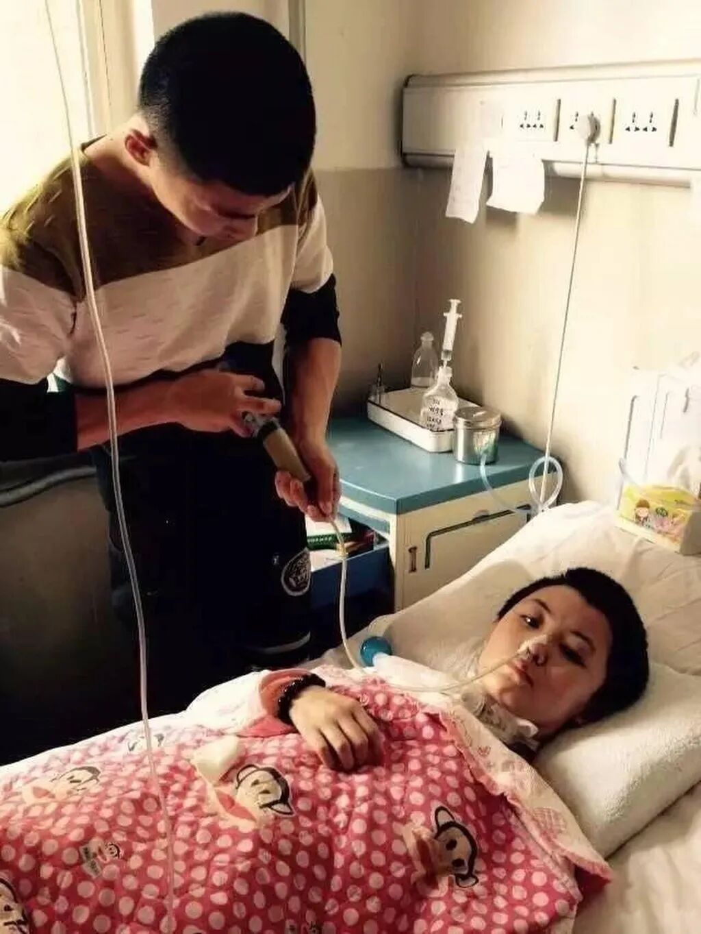 For two months, Liu, left, dedicated himself to her care, assisting her with daily tasks like changing her diapers, turning her in bed, and massaging her. Photo: Handout