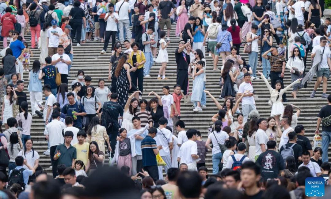 Tourists are pictured near the Ruins of St. Paul's in south China's Macao, May 3, 2025. The first three days of China's May Day holiday saw a significant influx of visitors to the Macao Special Administrative Region (SAR), injecting new vitality into the local tourism industry.  Statistics from the SAR's Public Security Police Force (CPSP) showed that from Thursday to Saturday, Macao's border checkpoints recorded entries and exits of 731,474, 837,062, and 826,273, respectively. Friday experienced the highest daily total, including 221,968 incoming visitors, marking the highest single-day record for inbound tourists since the pandemic.(Xinhua/Cheong Kam Ka)