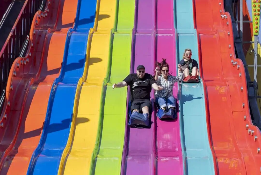 State Fair visitors take a ride on the new eight-lane Giant Slide on the midway on Friday, October 16, 2026 in Raleigh, N.C.