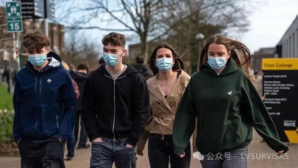 Four students wearing face masks walk through the University of Kent in Canterbury campus after an outbreak of meningitis caused the deaths of two people in March 2026.