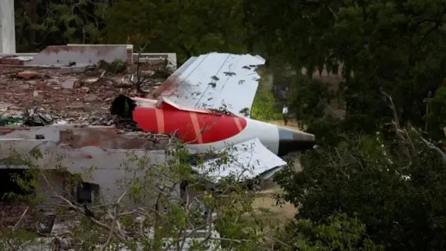 Plane sticking out of building,