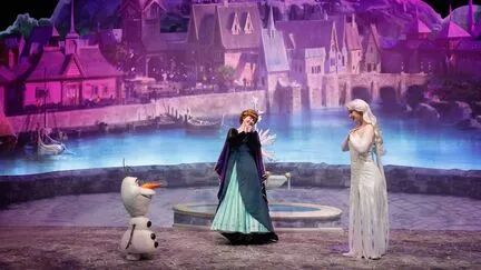 Les interprètes des personnages d'Anna (au centre), Olaf (à gauche) et Elsa (à droite) parlent du nouveau monde de "La Reine des neiges", à l'intérieur du Disney Adventure World (anciennement Walt Disney Studios), à Disneyland Paris, à Marne-la-Vallée, à l'est de Paris, le 24 novembre 2025. (GEOFFROY VAN DER HASSELT / AFP)