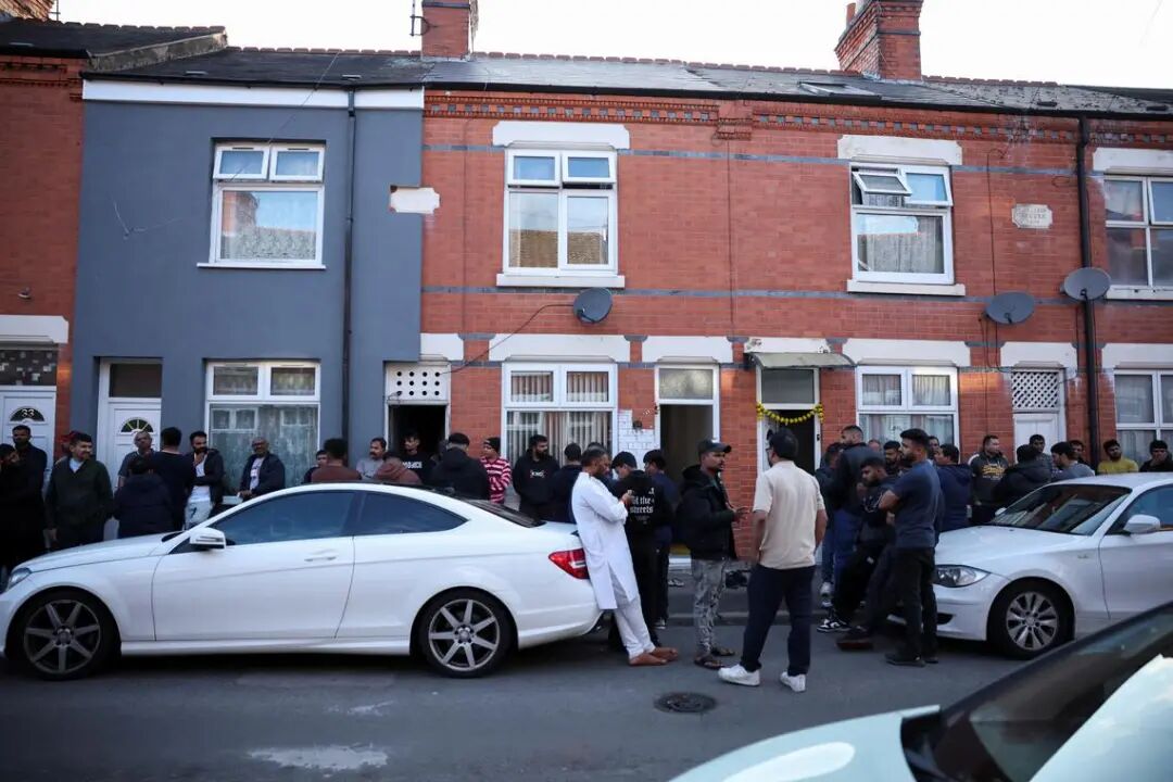 Members of local community stand outside family home of Ramesh Viswashkumar, a British survivor of the London-bound Air India aircraft crash near Ahmedabad Airport in India,  in Leicester, Britain, June 12, 2025. REUTERS/Phil Noble