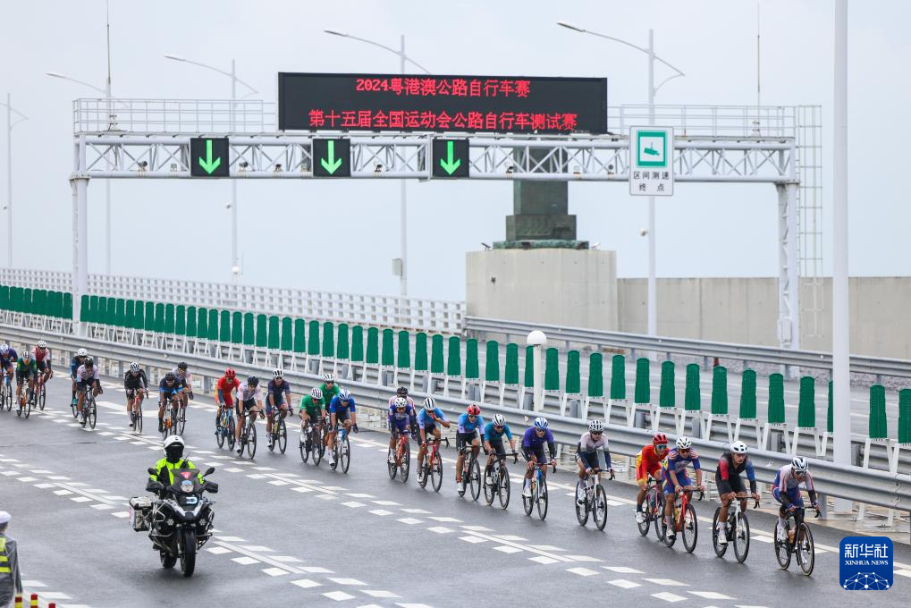2024粤港澳公路自行车赛暨第十五届全国运动会公路自行车测试赛，参赛选手骑行在港珠澳大桥海底隧道西入口。图/新华社记者 刘大伟 摄