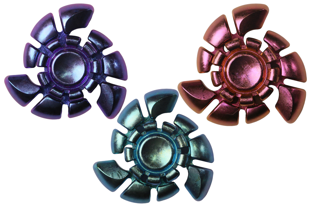 Three crystallized zirconium Nautilus Longji spinners in different colours, with light and shade across their curves and central buttons