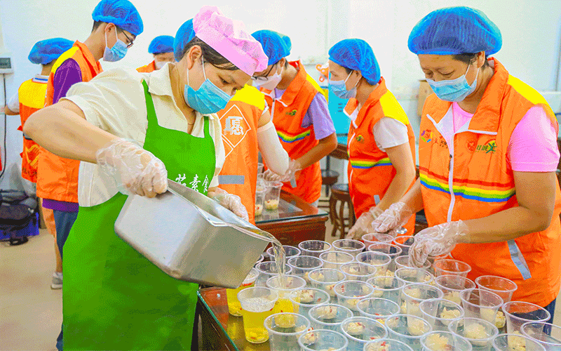 桂城彩虹之家义工队志愿者们在在分装、打包、搬运糖水。