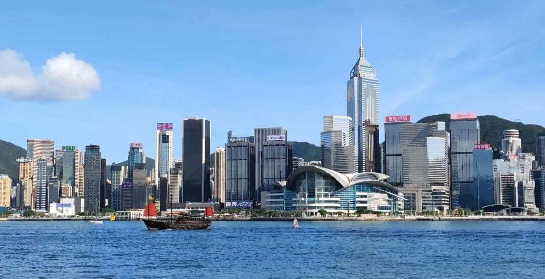 a boat in a body of water with a city in the background