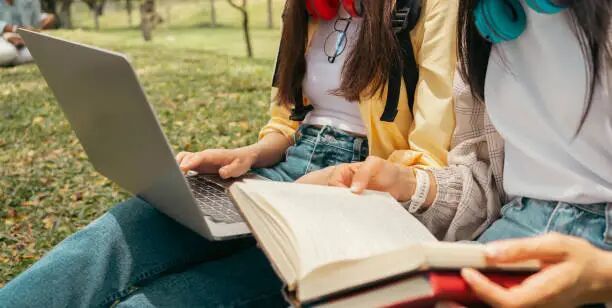 The Asian student community is enjoying university life. The Asian student community is enjoying university life. success in study receiving a scholarship. In their hands they held a book. using laptop for e-learning. international students stock pictures, royalty-free photos & images
