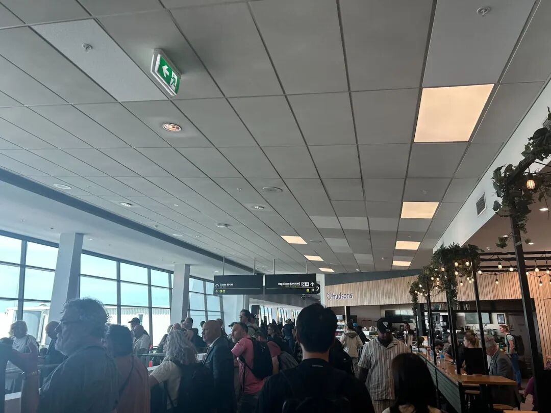 Passengers at departure gates at Auckland Airport await their delayed flights. Photo / NZ Herald