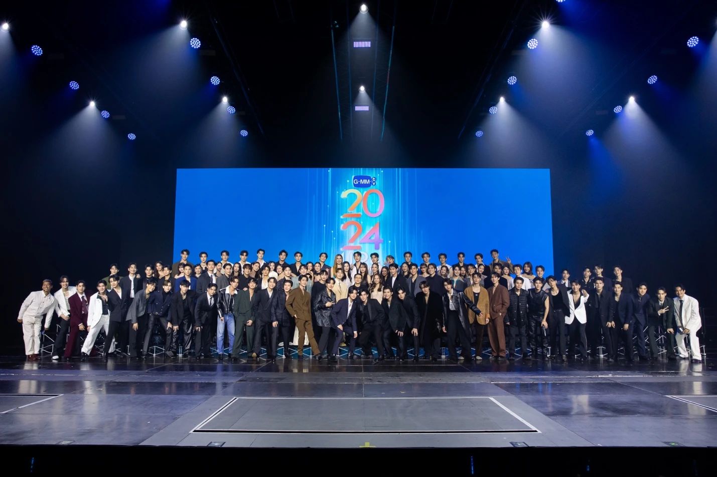 A group of people standing on a stageDescription automatically generated