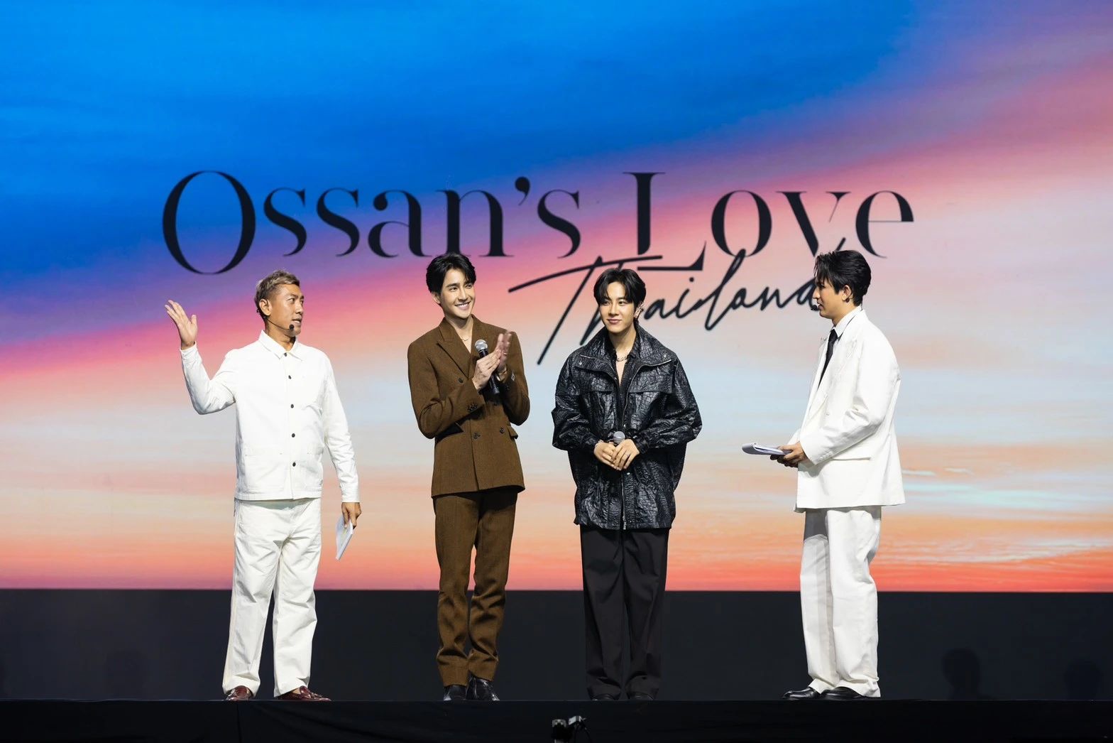 A group of men on a stageDescription automatically generated