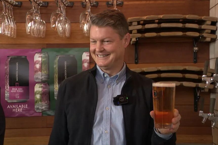 Ben Carroll holding a beer.