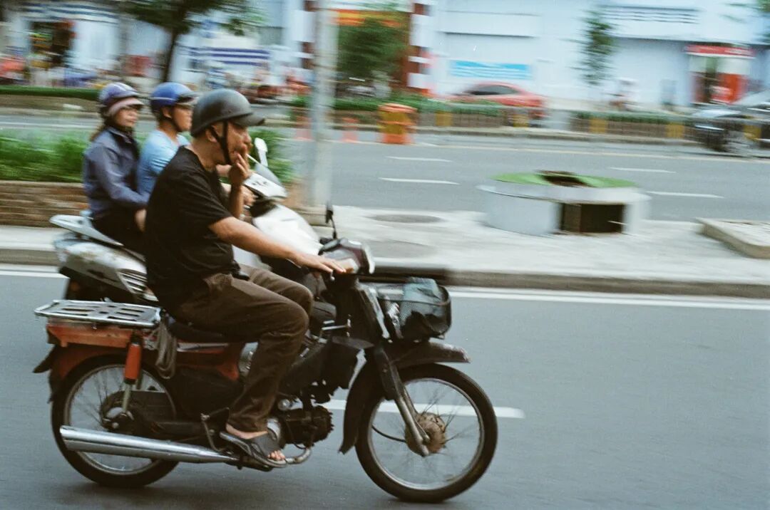 A man riding a motorcycle down a street
