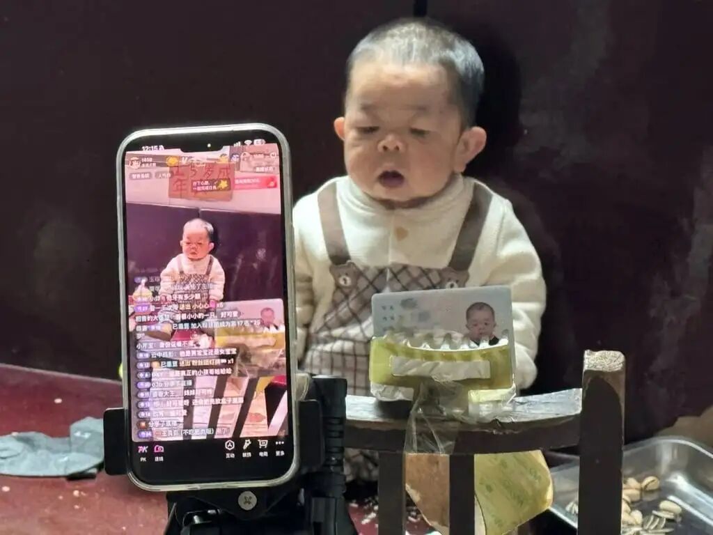Tiny Wang’s image is caught on the screen of a mobile phone. Photo: Handout