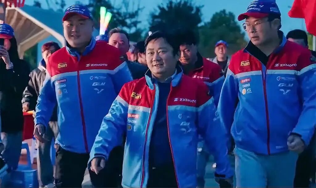Zhang Xue, centre, strides out with members of his team at an event. Photo: Instagram/ZXMOTO