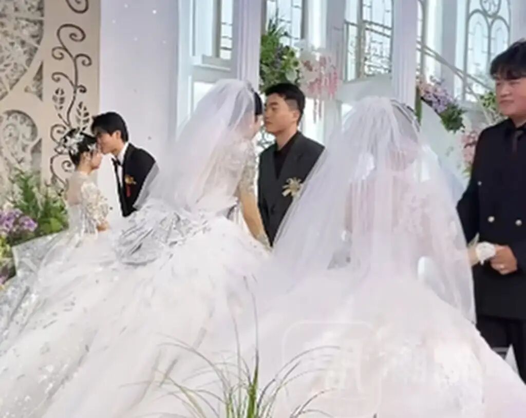 For part of the rare celebrations all three blushing brides wore white. Photo: Douyin