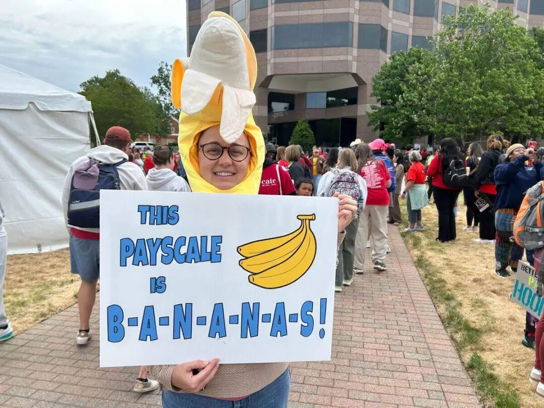 Annie Toth, a science teacher at Myers Park High School in Charlotte displays her sign before the teachers march in Raleigh.