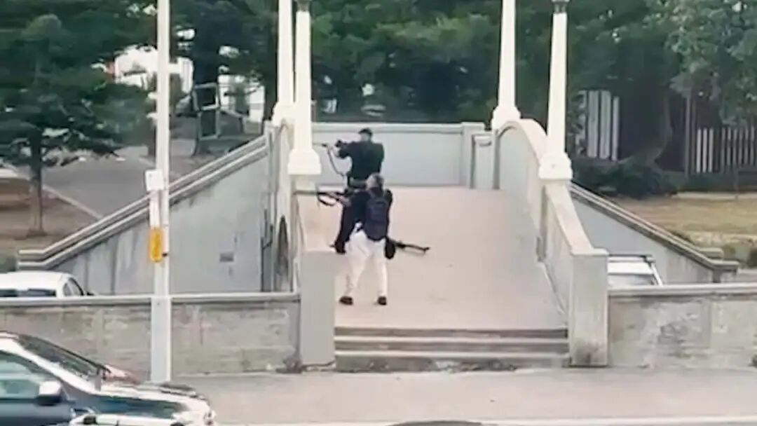 Bondi gunman motions to bystanders as they open fire from the footbridge