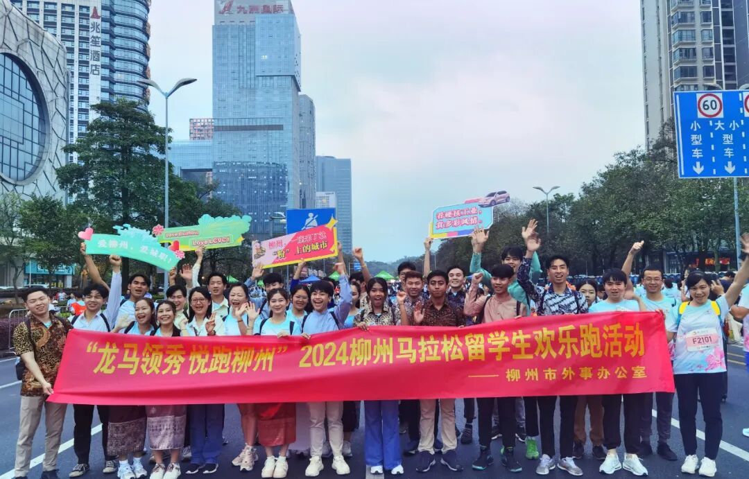 留学生与市外事办干部职工在选手集结出发区合影留念参加活动的老挝