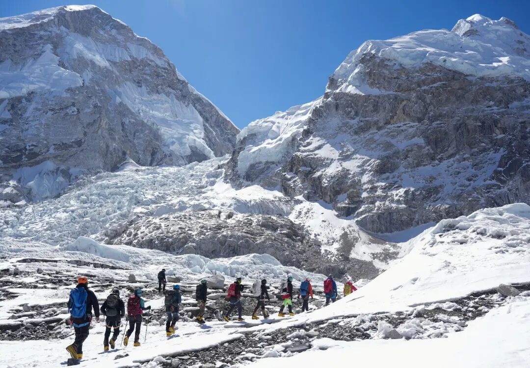 Members of an expedition team hike at Khumbu Icefall in Solukhumbu district, also known as the Everest region, in Nepal
