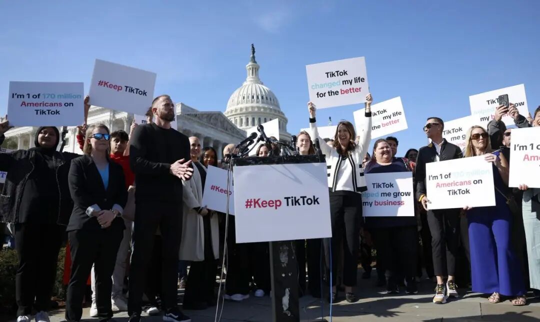 Protestors in front of the Capitol hold signs that say #KeepTikTok and TikTok changed my life for the better