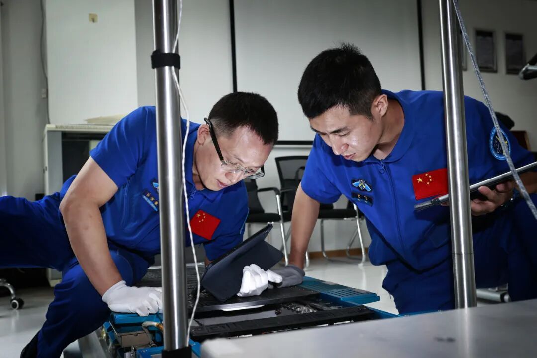 航天员张洪章（左）、武飞（右）在进行设备维修训练