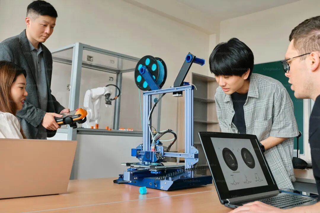 a group of people looking at a laptop